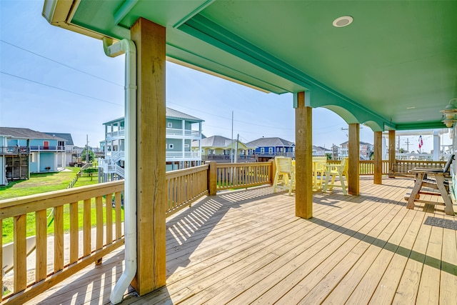 wooden deck featuring a lawn