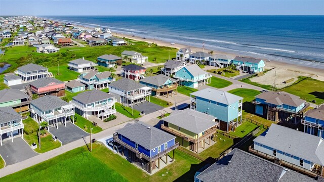 aerial view with a water view and a view of the beach