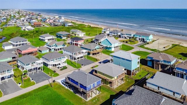 birds eye view of property with a residential view, a water view, and a view of the beach