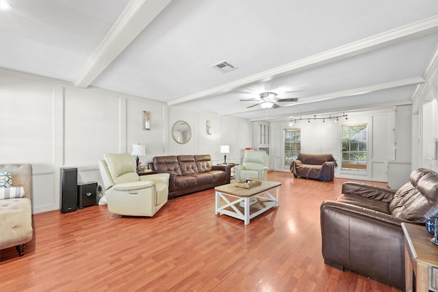 living room with beamed ceiling, crown molding, track lighting, ceiling fan, and hardwood / wood-style flooring