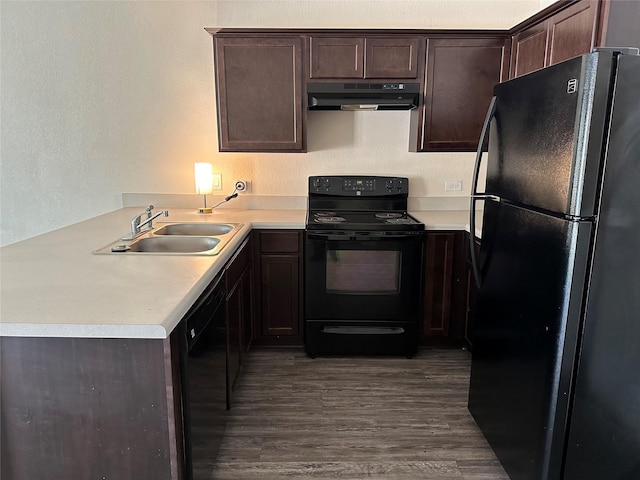 kitchen with kitchen peninsula, dark brown cabinetry, dark wood-type flooring, sink, and black appliances