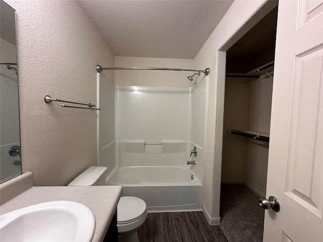 bathroom featuring hardwood / wood-style flooring, vanity, a textured ceiling, and toilet