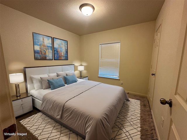 carpeted bedroom with a textured ceiling