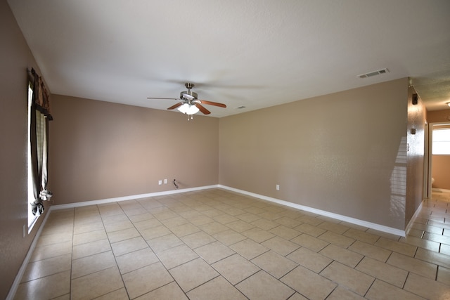 unfurnished room with light tile patterned floors and ceiling fan