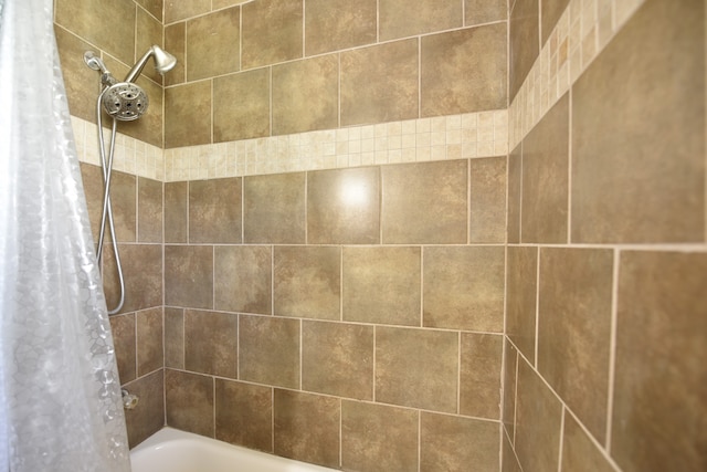 bathroom with shower / bath combo with shower curtain