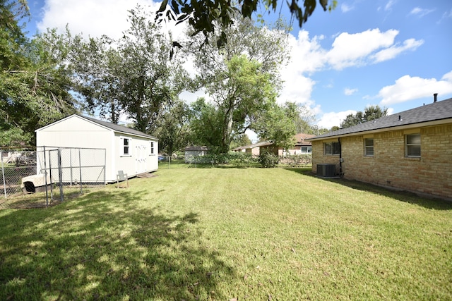 view of yard featuring central AC and a shed