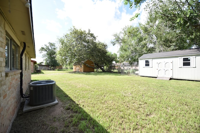 view of yard featuring a storage shed and central air condition unit