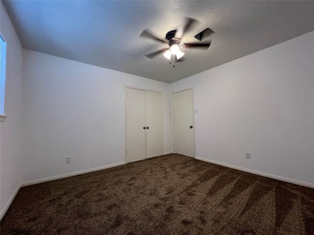 spare room featuring ceiling fan and carpet