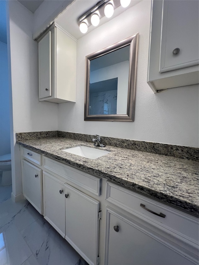 bathroom featuring vanity and toilet