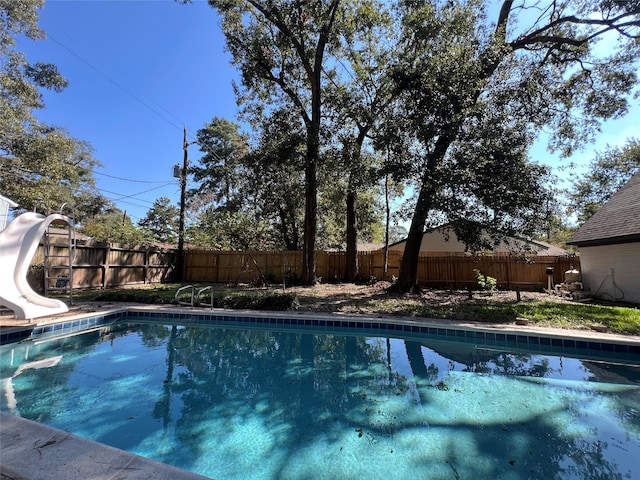 view of pool with a water slide