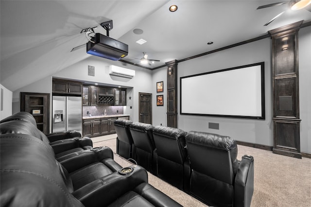 carpeted home theater featuring indoor wet bar, a wall unit AC, lofted ceiling, ornamental molding, and ceiling fan