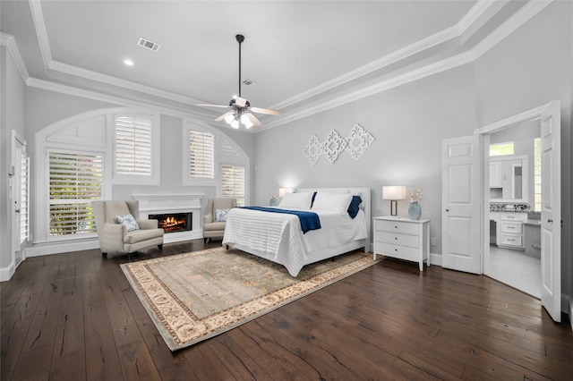 bedroom with ornamental molding, dark hardwood / wood-style flooring, and ceiling fan