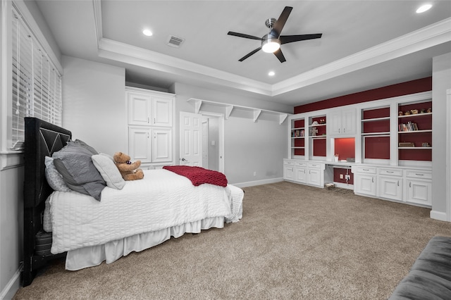 bedroom featuring ceiling fan, a raised ceiling, crown molding, and carpet flooring