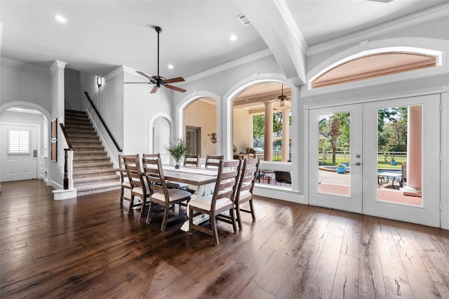 dining area with a wealth of natural light, dark wood-type flooring, ceiling fan, and french doors