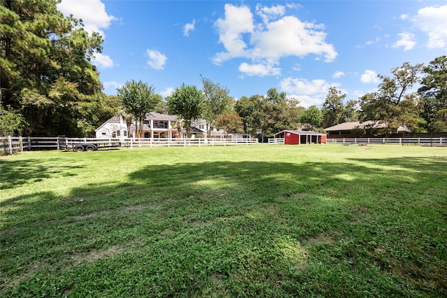 view of yard featuring a storage unit and a rural view