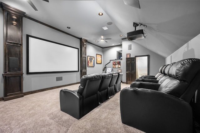 home theater room with ornamental molding, lofted ceiling, ceiling fan, and carpet floors