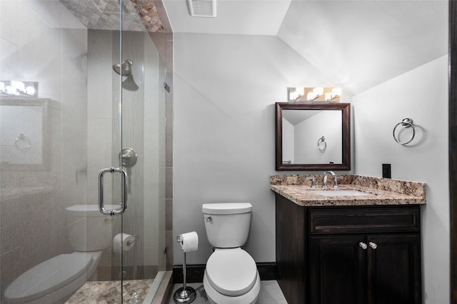 bathroom with vaulted ceiling, vanity, a shower with shower door, and toilet