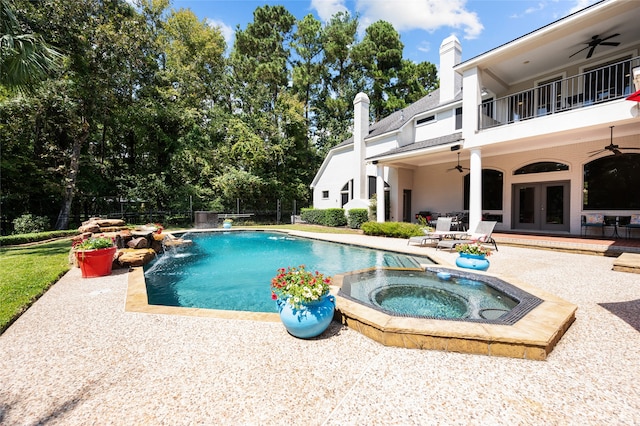 view of swimming pool with ceiling fan, a patio, an in ground hot tub, and pool water feature