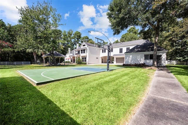 view of basketball court with a yard