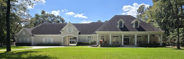 view of front of property with covered porch and a front yard