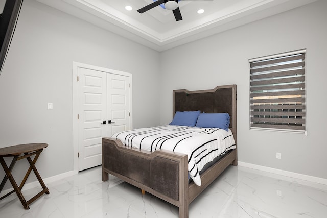 bedroom with ceiling fan and a closet