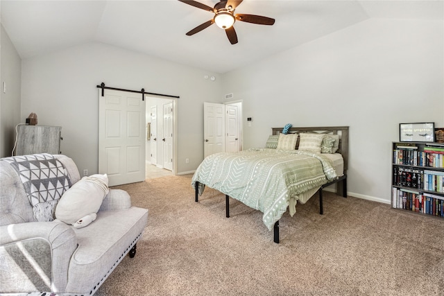 bedroom with a barn door, lofted ceiling, ceiling fan, and light colored carpet