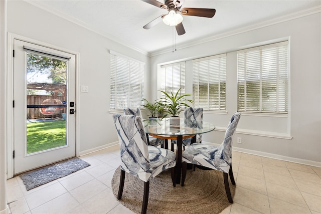 tiled dining area with ceiling fan, crown molding, and a healthy amount of sunlight