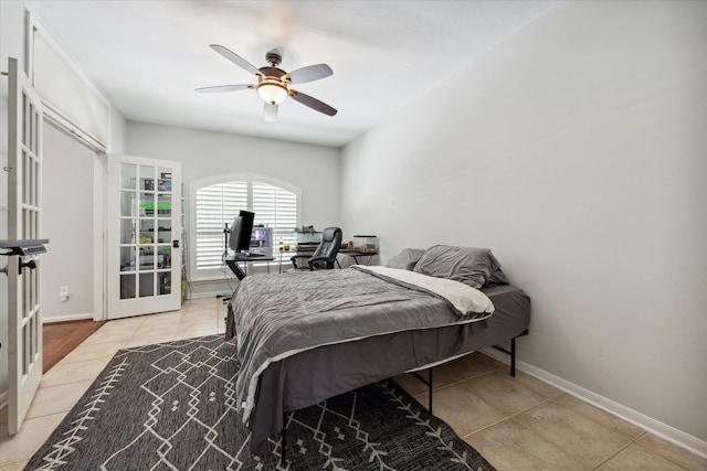 bedroom with ceiling fan and light tile patterned flooring