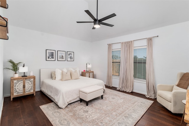 bedroom with ceiling fan, dark hardwood / wood-style flooring, and vaulted ceiling