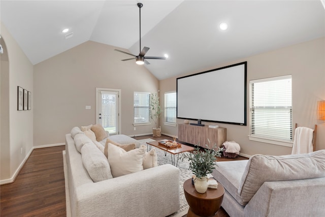 home theater room with dark hardwood / wood-style flooring, vaulted ceiling, and ceiling fan