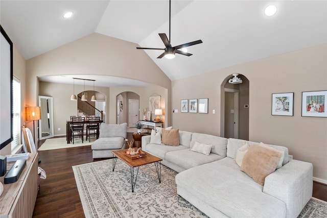 living room featuring ceiling fan, dark hardwood / wood-style floors, and high vaulted ceiling