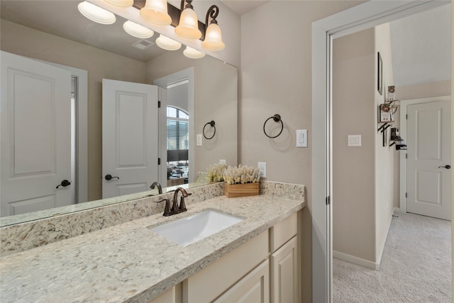 bathroom with vanity and a notable chandelier