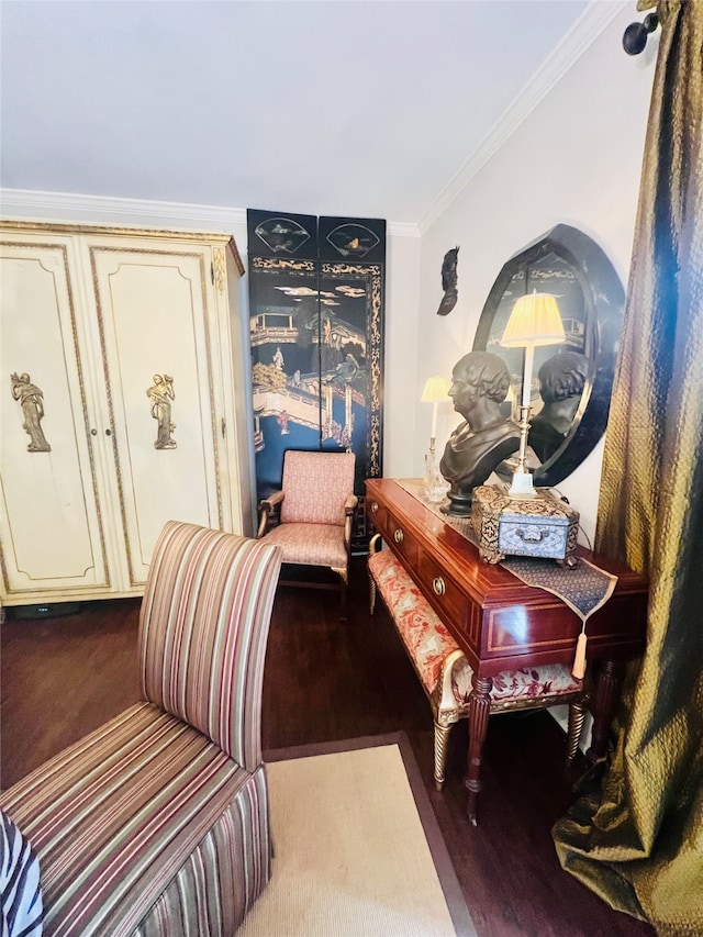 sitting room featuring crown molding and hardwood / wood-style flooring