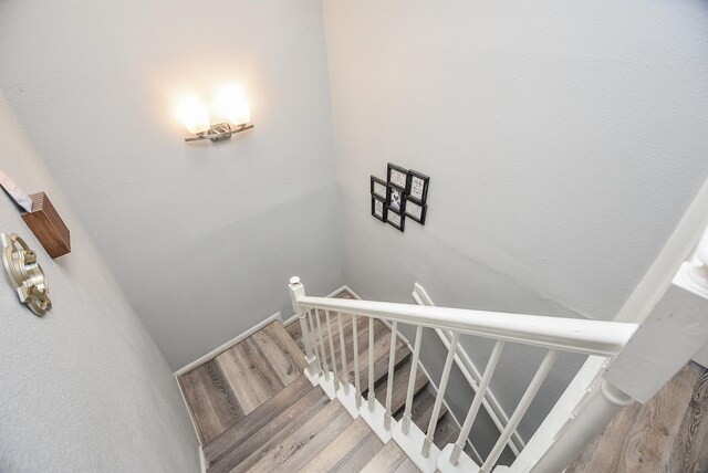 staircase featuring wood-type flooring