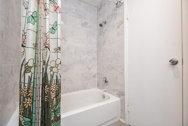 bathroom with shower / bath combination with curtain