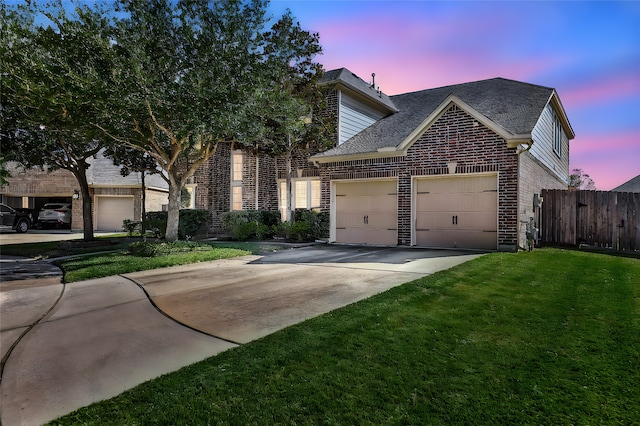 view of front facade featuring a garage and a yard