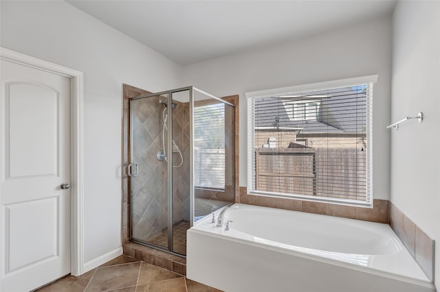 bathroom with separate shower and tub and tile patterned floors