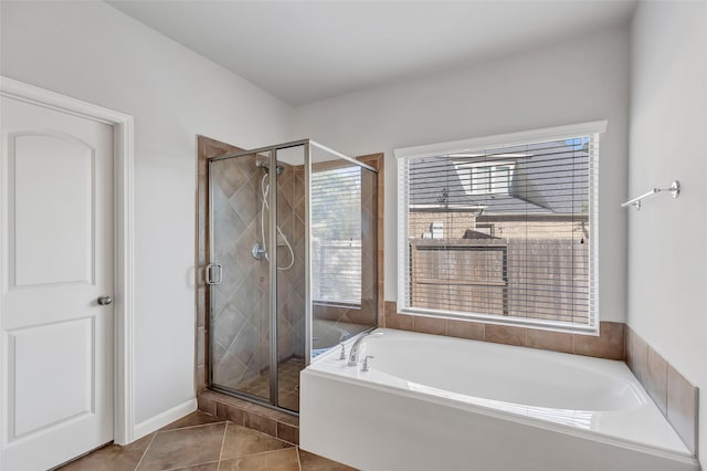 13607 Breakwater Path Loop, Houston, TX 77044 - bathroom featuring a shower stall, a garden tub, and tile patterned flooring