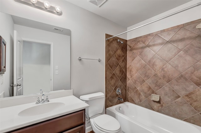 full bathroom featuring tiled shower / bath combo, vanity, and toilet