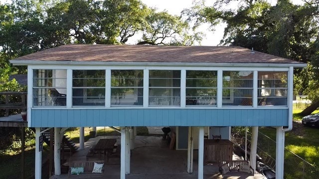 back of house with a sunroom