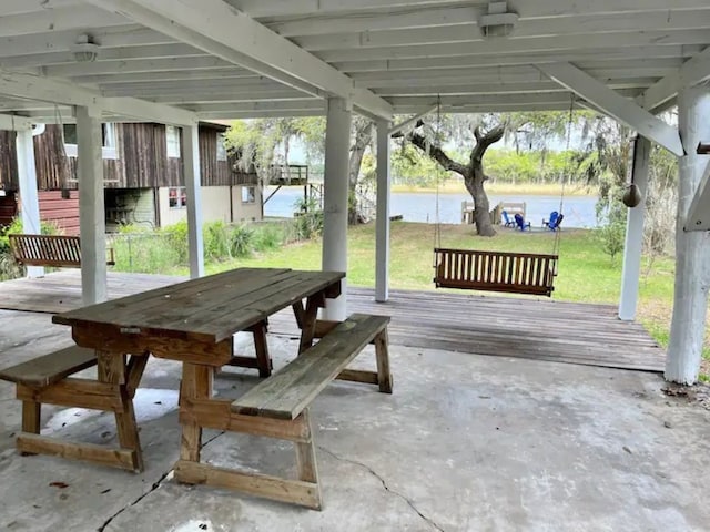 view of patio / terrace with a deck with water view