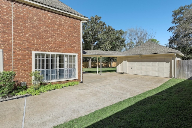 view of side of home featuring a yard and a garage