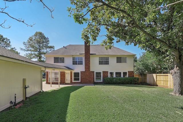 back of house featuring a yard