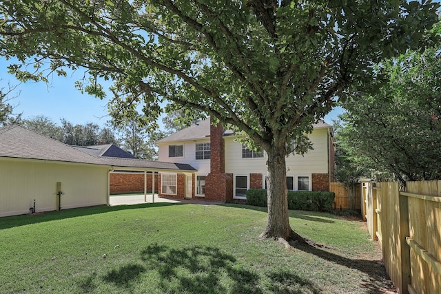 back of house featuring a yard