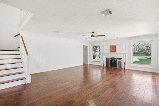 unfurnished living room with ceiling fan, dark hardwood / wood-style flooring, and a wealth of natural light