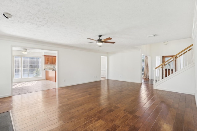 unfurnished living room featuring ceiling fan, dark hardwood / wood-style flooring, and a textured ceiling