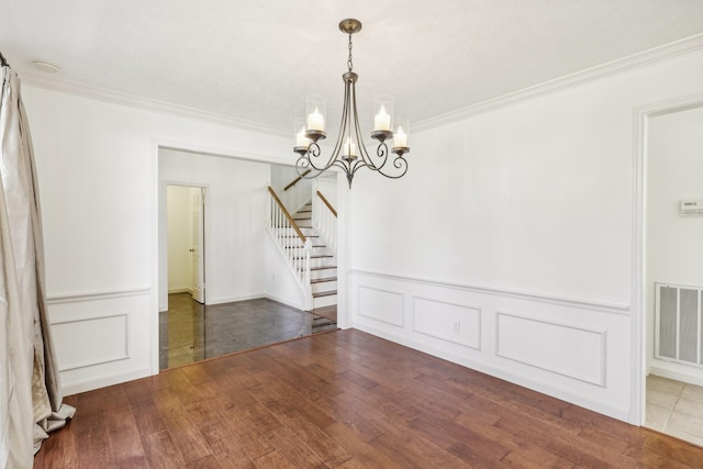 unfurnished dining area with crown molding, a notable chandelier, and hardwood / wood-style flooring