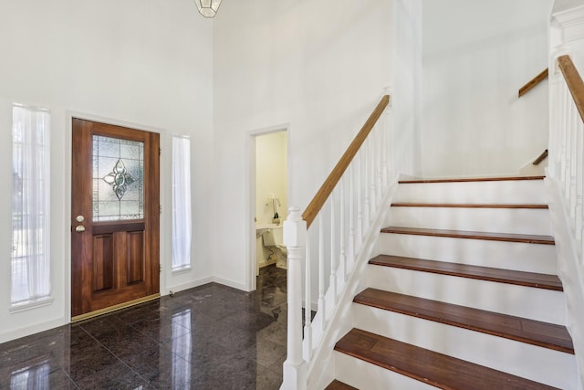 entrance foyer featuring a towering ceiling