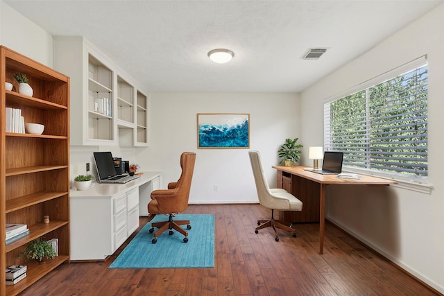 office with a textured ceiling and dark hardwood / wood-style flooring