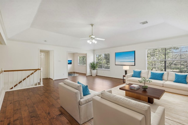 living room featuring a tray ceiling, a wealth of natural light, hardwood / wood-style floors, and ceiling fan